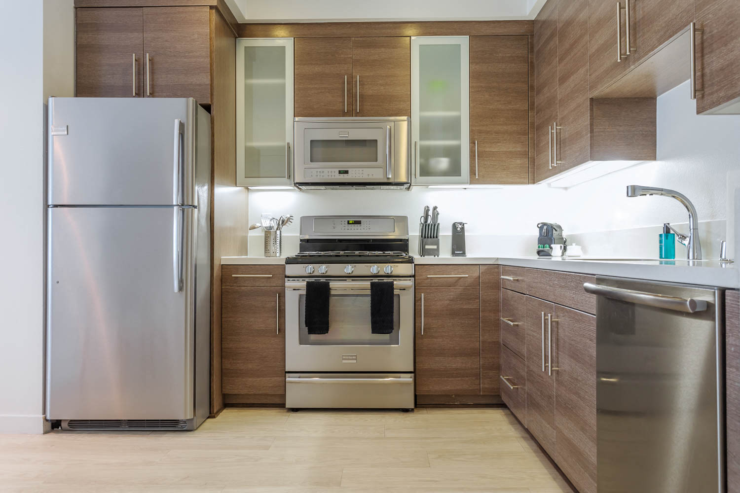 a kitchen with wooden cabinets and stainless steel appliances